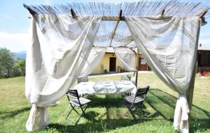 a table and chairs under a tent in a field at Umbria Montefranco in Montefranco +9 photos