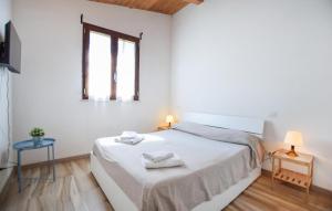 a white bedroom with a bed and two tables at Umbria Montefranco in Montefranco