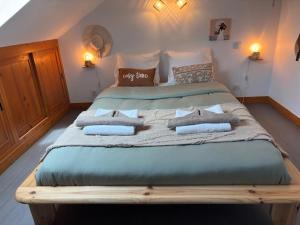 a large bed with pillows on it in a bedroom at Le Cocon Loire, 3-room apartment in La Ville-aux-Dames