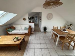 a living room with a couch and a table at Le Cocon Loire, 3-room apartment in La Ville-aux-Dames