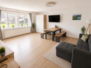 a living room with a couch and a table at Ferienwohnung Melissa in Unter Feuchten