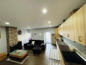 a living room with a couch and a table at Sofiamarholidays O Cantinho da Avó Bina in Moita