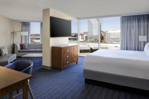 a hotel room with a bed and a large window at Hyatt Regency Baltimore in Baltimore +55 photos