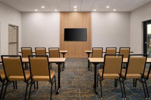 a conference room with tables and chairs and a flat screen tv at Hampton Inn & Suites Chadds Ford in Glen Mills +23 photos