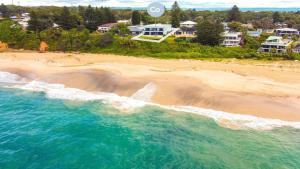 an aerial view of a beach with houses at 'Aloha Beach Retreat' by HolidayCo in Norah