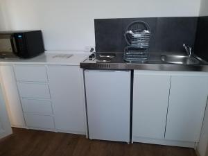 a kitchen with a sink and a counter top at Sucré salé in Le Port-des-Barques