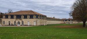 a large building with a green field in front of it at Sucré salé in Le Port-des-Barques