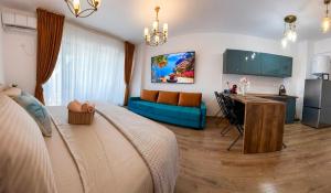 a living room with a bed and a blue couch at Saturn ROOMS in Saturn