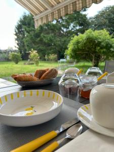 a table with plates of food and bread on it at Angel du Mont in Pontorson +33 photos