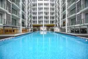 a large swimming pool in the middle of a building at Wyndham Garden Manila Bay in Manila