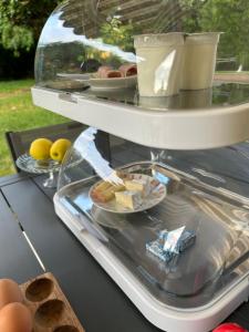 a refrigerator with food and eggs on a table at Angel du Mont in Pontorson