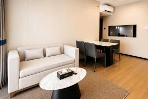 a living room with a couch and a table at Wyndham Garden Manila Bay in Manila