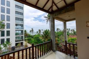 a balcony with a view of a building at Soulinn Regina Weligama in Weligama