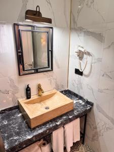 a bathroom with a wooden sink and a mirror at The Independent Hotel Taksim in Istanbul +31 photos