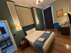 a bedroom with a bed with two towels on it at The Independent Hotel Taksim in Istanbul