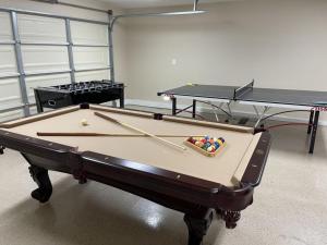 two ping pong tables in a room with two tables at Fantastic 6 bedroom, 4 & Half bath home (4 master Suites), pool home in Anaheim