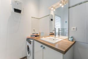 a bathroom with a sink and a washing machine at Gîte le Petit Luberon - Lisianthus in Cabrières-dʼAvignon +17 photos