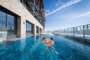 a rendering of a family in the water in a swimming pool at Skistar Lodge Trysil in Trysil