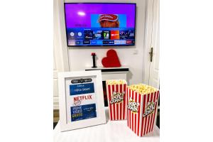 a room with popcorn and a flat screen tv at Cubo's Poseidon Suites 3 & Pool for Adults in Benalmádena