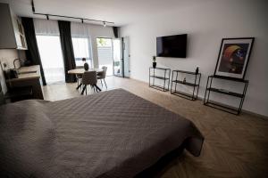 a bedroom with a bed and a table with chairs at Incanto Rentals in Silistra