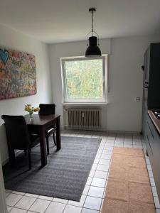 a dining room with a table and a window at Village Apartment Rheinbreitbach in Rheinbreitbach