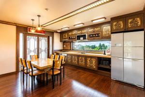 a kitchen with a table and chairs in a kitchen at Jeju Nine resort in Jeju