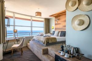 a bedroom with a bed and a view of the ocean at Baya Hotel in Capbreton +92 photos