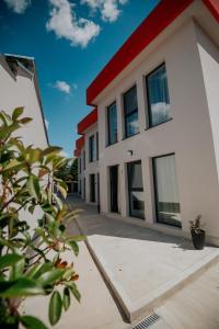 a white building with a red roof at Incanto Rentals in Silistra