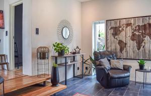 a living room with a leather chair and a world map on the wall at 4 Bedroom Lovely Home In Simrishamn in Simrishamn