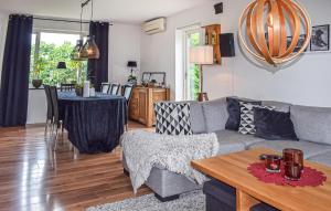 a living room with a couch and a table at 4 Bedroom Lovely Home In Simrishamn in Simrishamn