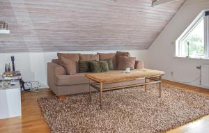 a living room with a couch and a coffee table at 4 Bedroom Lovely Home In Simrishamn in Simrishamn