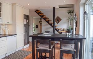 a kitchen with a table and chairs and a staircase at 4 Bedroom Lovely Home In Simrishamn in Simrishamn
