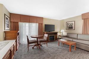a hotel room with a couch and a table at Rodeway Inn Columbia Mall Loop in Grand Forks