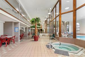 a large room with a hot tub and a restaurant at Rodeway Inn Columbia Mall Loop in Grand Forks