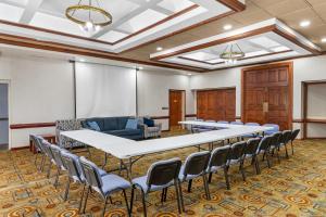 a conference room with tables and chairs and a whiteboard at Quality Inn & Suites Kansas City - Independence I-70 East in Independence