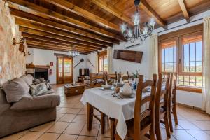 a kitchen and living room with a table and chairs at Casa Rural Cortijo Celdran in Vélez-Rubio