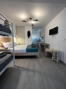 a bedroom with a bunk bed and a desk at sun studios in Mikonos