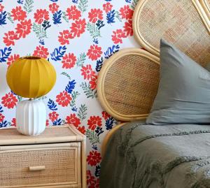 a bedroom with a flower patterned wall with a bed at Architect-Designed Villa with Heated Indoor Pool in Oslip