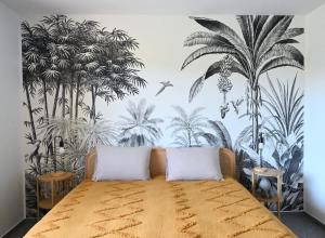 a bedroom with a bed with a mural of palm trees at Architect-Designed Villa with Heated Indoor Pool in Oslip