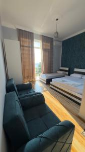 a living room with a couch and a bed at Grand Hotel Kobuleti in Kobuleti