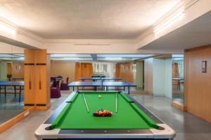 a pool table in a room with tables at Velvet Resort Khandala in Khandāla