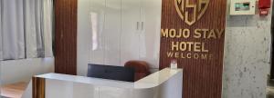 a hotel lobby with a desk with a laptop at Mojo stay hotel in Ahmedabad