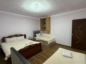 a hotel room with two beds and a window at Narine Bed and Breakfast, Tour in Tatʼev