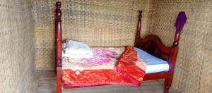 a small bed in a corner of a room at WYCLIFF BnB in Chabahinga