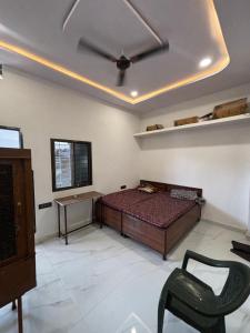 a bedroom with a bed and a ceiling fan at Hotel Ashish in Kaohni