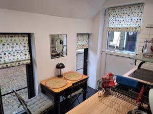 a small room with a table and chairs and windows at Le clos d'oli in Wamin +11 photos