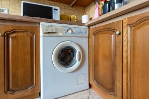 a white washer and dryer under a kitchen counter at Swimming Pool - Valley View Home Drobonik in Drobonik