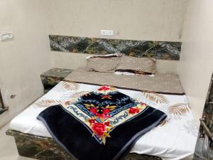 a bedroom with two beds with a blanket on them at Radha rani sadan in Vrindāvan