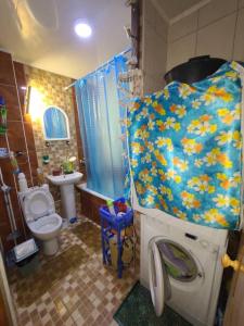 a bathroom with a toilet a sink and a shower at Квартира 89 in Bishkek