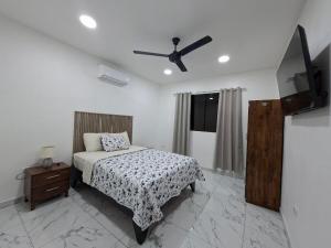 a bedroom with a bed and a ceiling fan at Lions Houses in Parrita